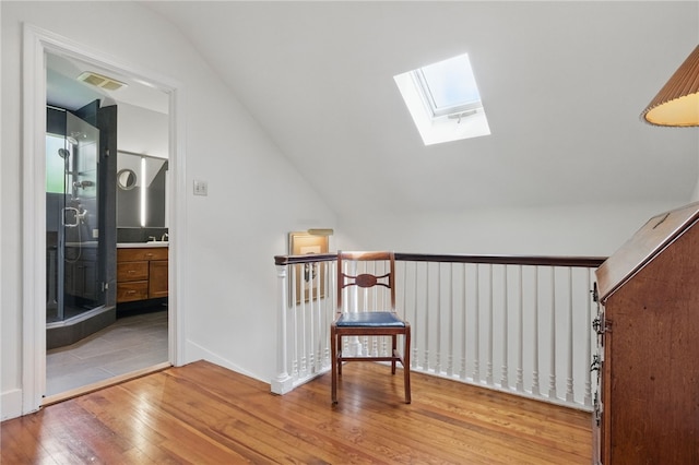 1017 Lancaster Ave, Regent Square, PA 15218 - stairway featuring hardwood / wood-style floors, vaulted ceiling, and a skylight