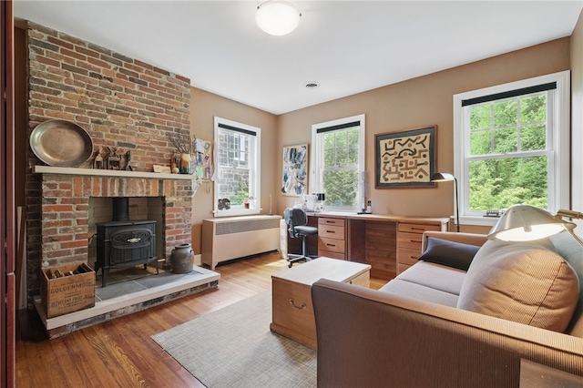 1017 Lancaster Ave, Regent Square, PA 15218 - office with radiator heating unit, a wood stove, and light wood finished floors