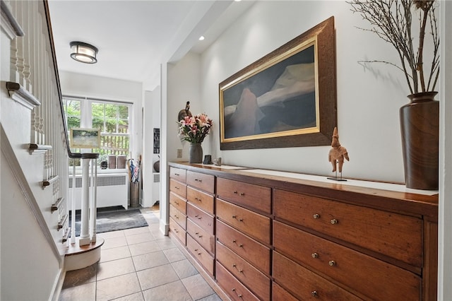 1017 Lancaster Ave, Regent Square, PA 15218 - hallway with radiator, light tile patterned floors, and stairs