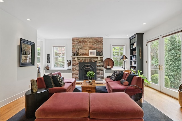 1017 Lancaster Ave, Regent Square, PA 15218 - living room with wood finished floors, recessed lighting, a brick fireplace, and baseboards