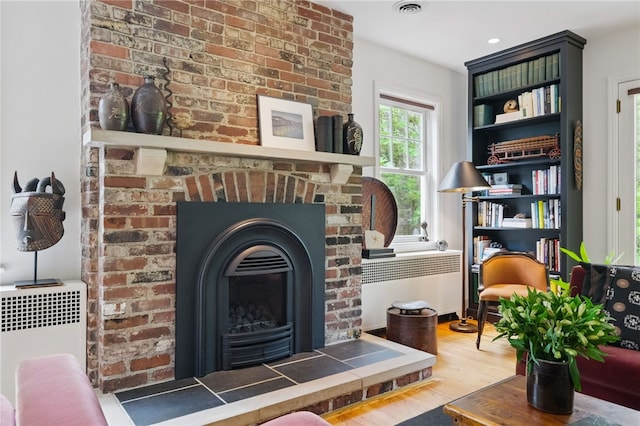 1017 Lancaster Ave, Regent Square, PA 15218 - living area with wood finished floors and a brick fireplace