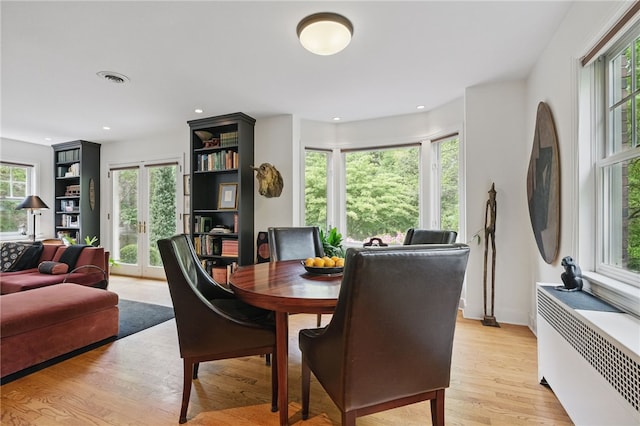 1017 Lancaster Ave, Regent Square, PA 15218 - dining room featuring radiator heating unit, light wood-style floors, and recessed lighting