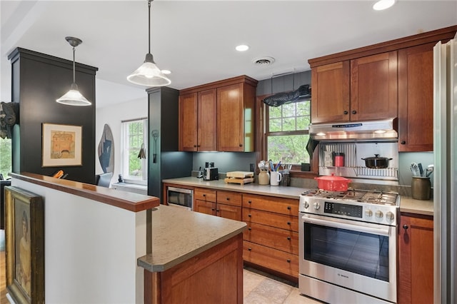 1017 Lancaster Ave, Regent Square, PA 15218 - kitchen featuring stainless steel appliances, under cabinet range hood, healthy amount of natural light, brown cabinets, and recessed lighting
