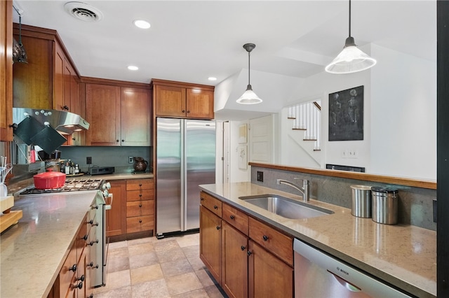 1017 Lancaster Ave, Regent Square, PA 15218 - kitchen with appliances with stainless steel finishes, a sink, brown cabinets, pendant lighting, and recessed lighting