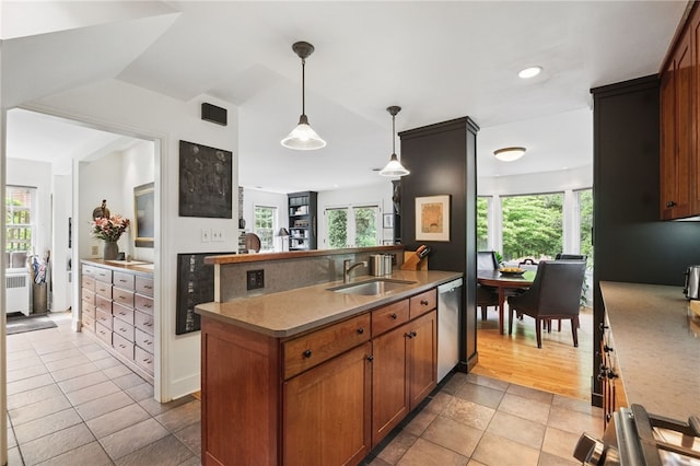 1017 Lancaster Ave, Regent Square, PA 15218 - kitchen with a sink, dishwasher, hanging light fixtures, brown cabinetry, and light tile patterned floors