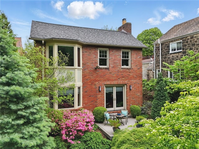 1017 Lancaster Ave, Regent Square, PA 15218 - back of house featuring a chimney, brick siding, a shingled roof, and a patio area