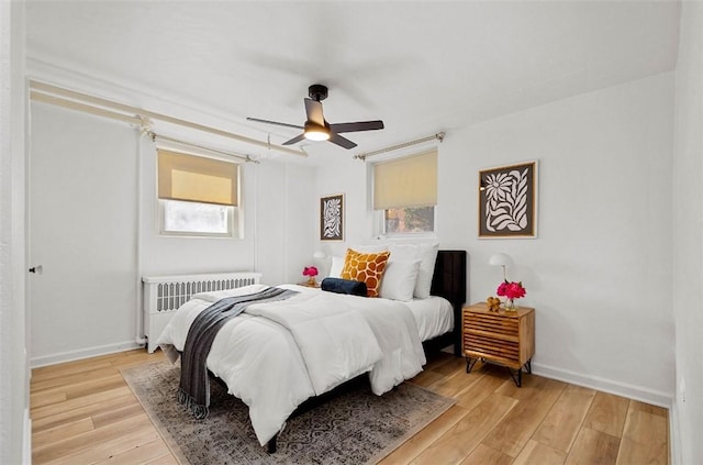 101 Lawncroft Ave Unit A7, Mt Lebanon, PA 15228 - bedroom featuring radiator, multiple windows, light wood finished floors, and baseboards