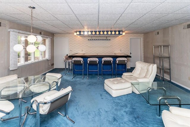 302 Derrick Ave, South Union Twp, PA 15401 - carpeted living area featuring bar and wood walls