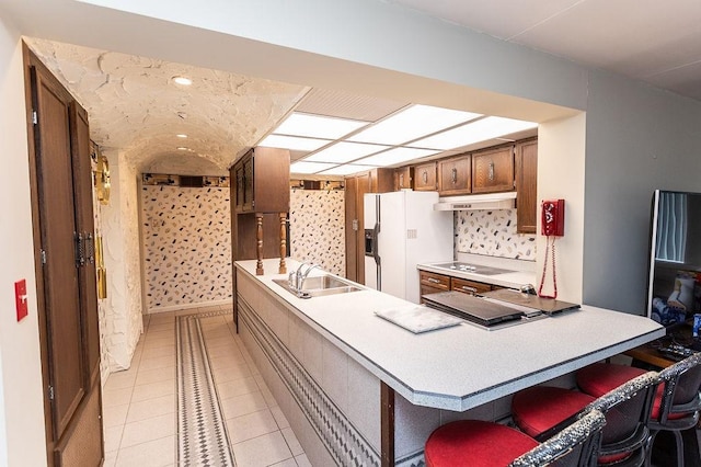 302 Derrick Ave, South Union Twp, PA 15401 - kitchen with a sink, under cabinet range hood, black electric cooktop, white fridge with ice dispenser, and a peninsula