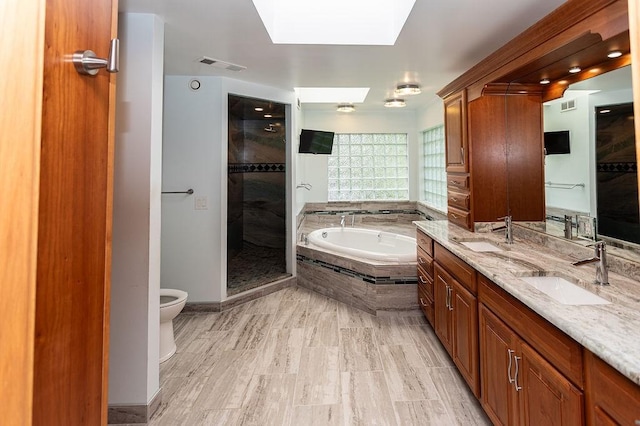 302 Derrick Ave, South Union Twp, PA 15401 - full bath featuring a bath, toilet, a skylight, tiled shower, and double vanity