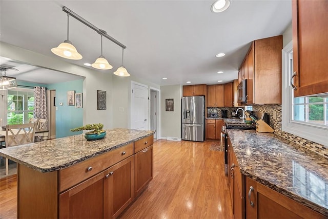 38 Elwyn Ave, Collier Twp, PA 15106 - kitchen featuring appliances with stainless steel finishes, brown cabinets, light wood-style floors, tasteful backsplash, and recessed lighting