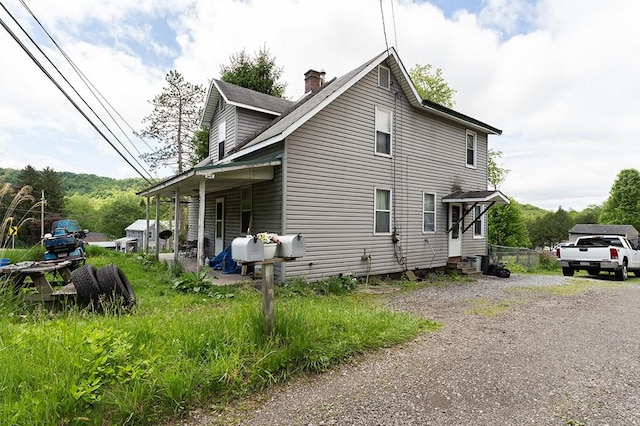 6071 Rte 711, Saint Clair Twp, PA 15944 - view of property exterior featuring entry steps and a chimney