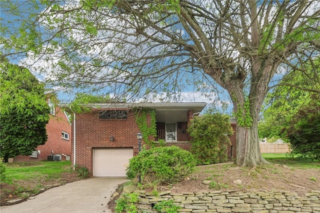 2403 Marion St, Hopewell Twp Bea, PA 15001 - view of front of home featuring brick siding, concrete driveway, a garage, and central AC unit