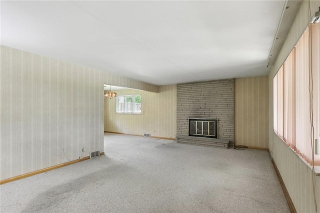 2403 Marion St, Hopewell Twp Bea, PA 15001 - unfurnished living room with wallpapered walls, carpet floors, a brick fireplace, and a chandelier