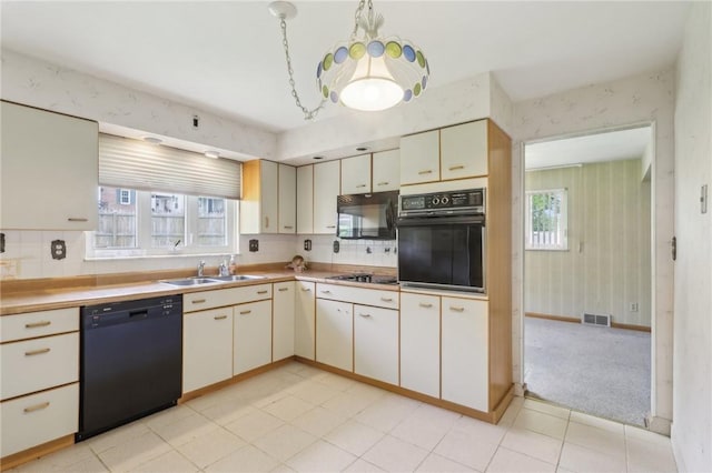 2403 Marion St, Hopewell Twp Bea, PA 15001 - kitchen featuring black appliances, a sink, cream cabinets, backsplash, and wallpapered walls