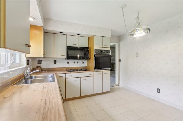 2403 Marion St, Hopewell Twp Bea, PA 15001 - kitchen with black appliances, a sink, light countertops, decorative backsplash, and wallpapered walls
