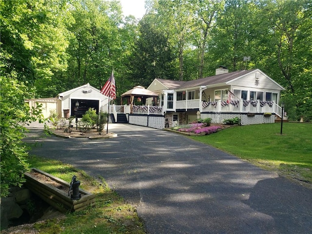2381 Lake Rd, Jefferson Twp Mer, PA 16150 - view of front of home featuring an outdoor structure, a front yard, a porch, asphalt driveway, and a chimney