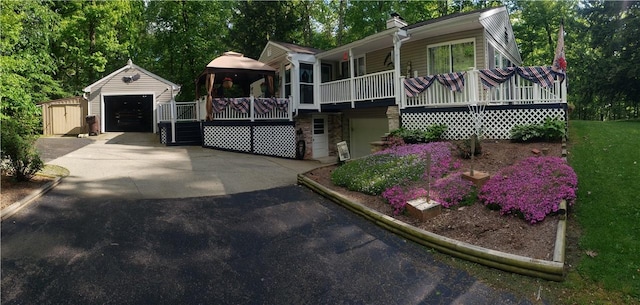 2381 Lake Rd, Jefferson Twp Mer, PA 16150 - view of front of property featuring an outbuilding, a garage, driveway, stone siding, and a chimney