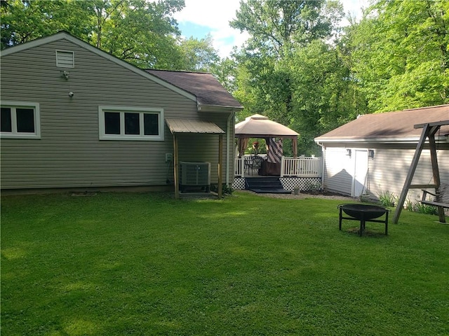 2381 Lake Rd, Jefferson Twp Mer, PA 16150 - rear view of house featuring a gazebo, central AC unit, a lawn, a wooden deck, and an outdoor fire pit