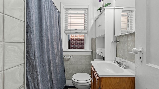 427 W Warrington Ave, Beltzhoover, PA 15210 - bathroom featuring tile walls, toilet, and vanity