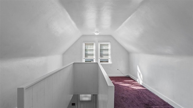 427 W Warrington Ave, Beltzhoover, PA 15210 - additional living space featuring dark carpet, lofted ceiling, baseboards, and a textured ceiling
