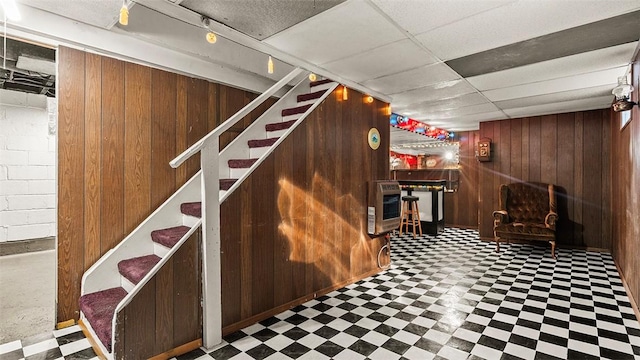 427 W Warrington Ave, Beltzhoover, PA 15210 - finished below grade area with wooden walls, tile patterned floors, heating unit, stairway, and a paneled ceiling