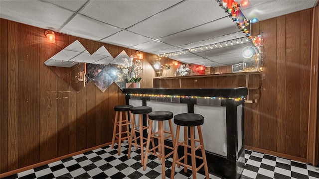 427 W Warrington Ave, Beltzhoover, PA 15210 - indoor bar featuring tile patterned floors, wood walls, and a drop ceiling