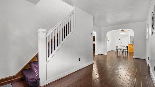 427 W Warrington Ave, Beltzhoover, PA 15210 - entrance foyer with arched walkways, stairway, dark wood-type flooring, baseboards, and ceiling fan