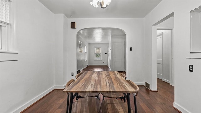 427 W Warrington Ave, Beltzhoover, PA 15210 - dining room featuring arched walkways, wood finished floors, baseboards, and a chandelier