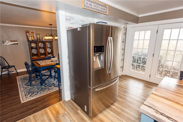 545 Roseland Ave, Ross Twp, PA 15214 - kitchen with stainless steel fridge, wood finished floors, a chandelier, ornamental molding, and baseboards