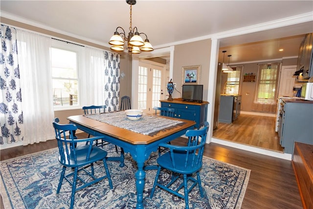 545 Roseland Ave, Ross Twp, PA 15214 - dining area featuring a chandelier, dark wood-type flooring, crown molding, and baseboards