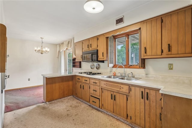 137 Terry Ln, Center Twp Bea, PA 15061 - kitchen featuring black microwave, a sink, light countertops, a peninsula, and gas stovetop