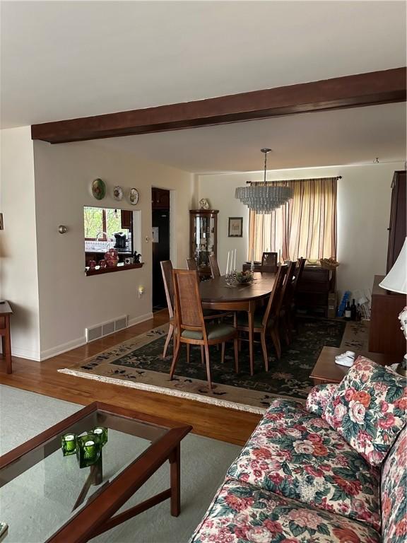 141 Mar Vel Dr, Center Twp But, PA 16001 - dining space featuring wood finished floors, beamed ceiling, and a chandelier