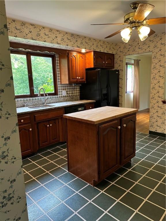 141 Mar Vel Dr, Center Twp But, PA 16001 - kitchen with black fridge, a sink, wood counters, a center island, and wallpapered walls