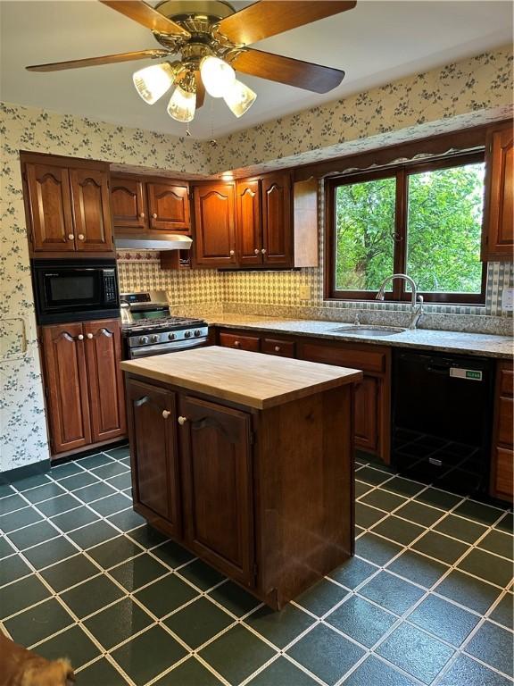 141 Mar Vel Dr, Center Twp But, PA 16001 - kitchen featuring black appliances, butcher block countertops, under cabinet range hood, dark tile patterned flooring, and wallpapered walls