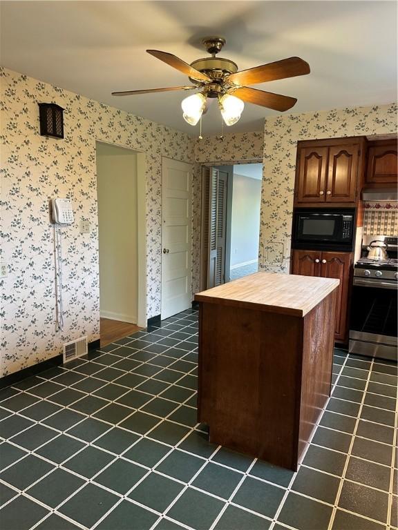 141 Mar Vel Dr, Center Twp But, PA 16001 - kitchen with stainless steel range with gas cooktop, black microwave, butcher block counters, a ceiling fan, and dark tile patterned floors