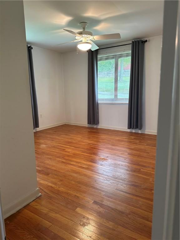141 Mar Vel Dr, Center Twp But, PA 16001 - empty room featuring hardwood / wood-style flooring, a ceiling fan, and baseboards