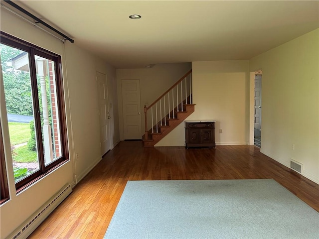 141 Mar Vel Dr, Center Twp But, PA 16001 - unfurnished living room featuring a baseboard radiator, wood finished floors, stairs, baseboards, and recessed lighting