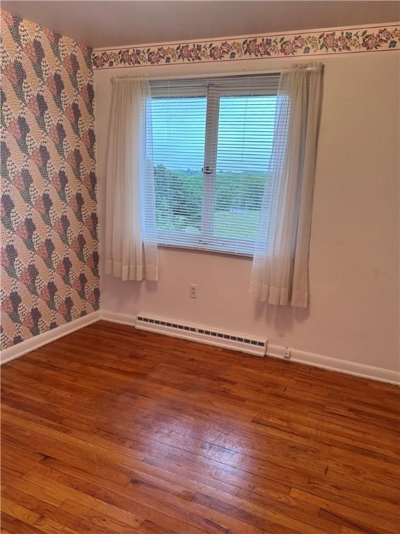 141 Mar Vel Dr, Center Twp But, PA 16001 - unfurnished room with baseboard heating, baseboards, and hardwood / wood-style floors