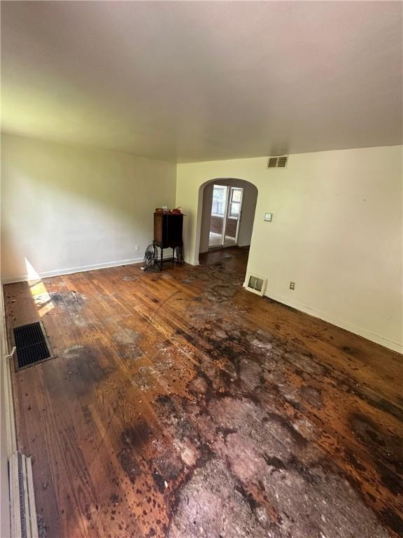 2905 Blackridge Ave, Penn Hills, PA 15235 - unfurnished living room featuring arched walkways, hardwood / wood-style flooring, and baseboards