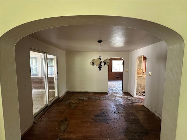 2905 Blackridge Ave, Penn Hills, PA 15235 - unfurnished dining area with arched walkways, hardwood / wood-style flooring, and baseboards
