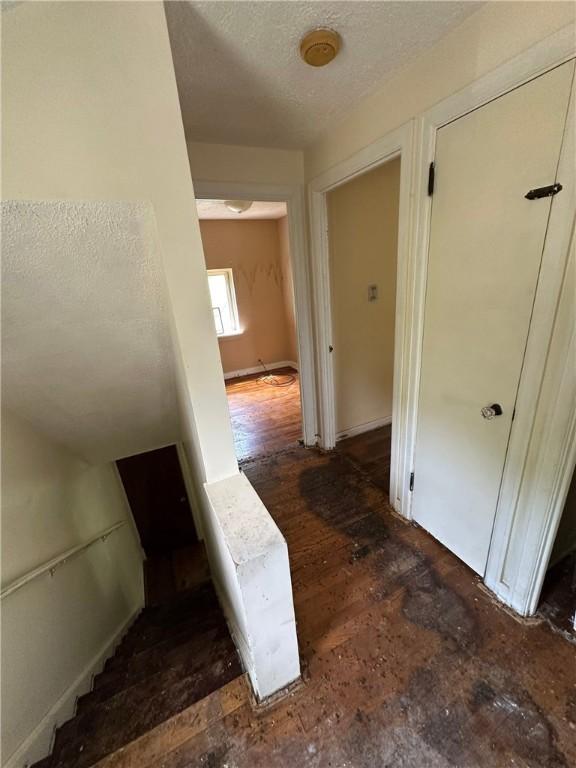 2905 Blackridge Ave, Penn Hills, PA 15235 - stairs with a textured ceiling and wood finished floors