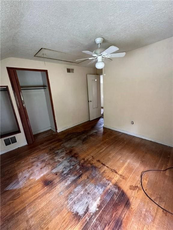 2905 Blackridge Ave, Penn Hills, PA 15235 - unfurnished bedroom with attic access, wood-type flooring, a textured ceiling, a closet, and a ceiling fan