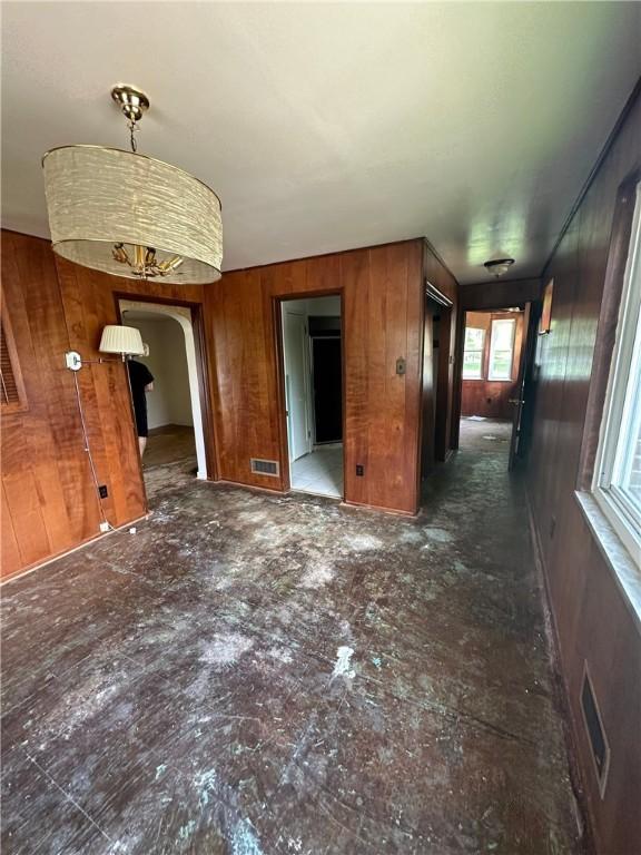 2905 Blackridge Ave, Penn Hills, PA 15235 - unfurnished living room featuring wood walls and arched walkways