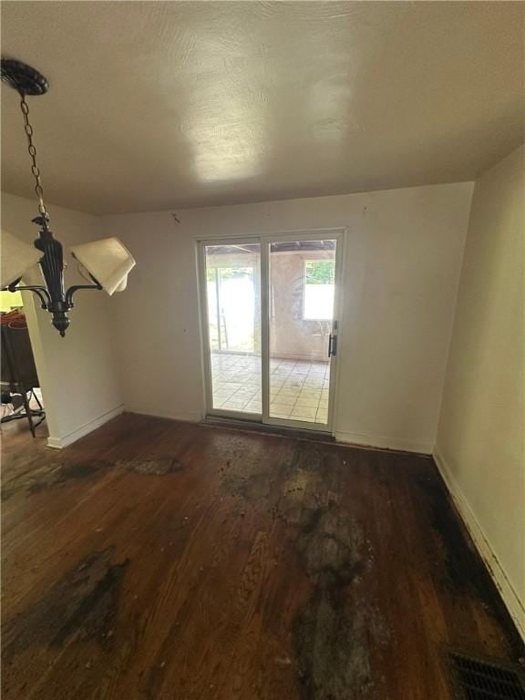 2905 Blackridge Ave, Penn Hills, PA 15235 - unfurnished living room with wood finished floors, baseboards, and a chandelier