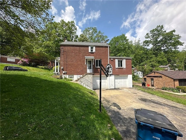 2905 Blackridge Ave, Penn Hills, PA 15235 - back of house with a garage, driveway, brick siding, and a yard