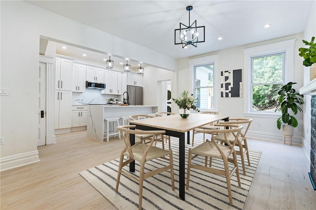 5415 Black St, East Liberty, PA 15206 - dining area featuring baseboards, light wood-type flooring, a chandelier, and recessed lighting
