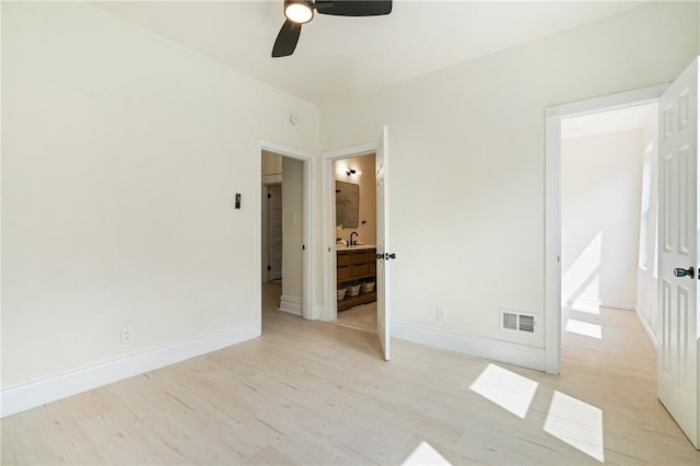 5415 Black St, East Liberty, PA 15206 - unfurnished bedroom featuring a sink, light wood-type flooring, baseboards, connected bathroom, and a ceiling fan