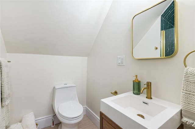 5415 Black St, East Liberty, PA 15206 - bathroom featuring toilet, lofted ceiling, and vanity