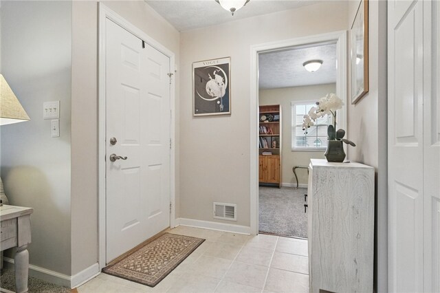146 Barrington Dr, Collier Twp, PA 15071 - foyer with baseboards, light tile patterned floors, and a textured ceiling